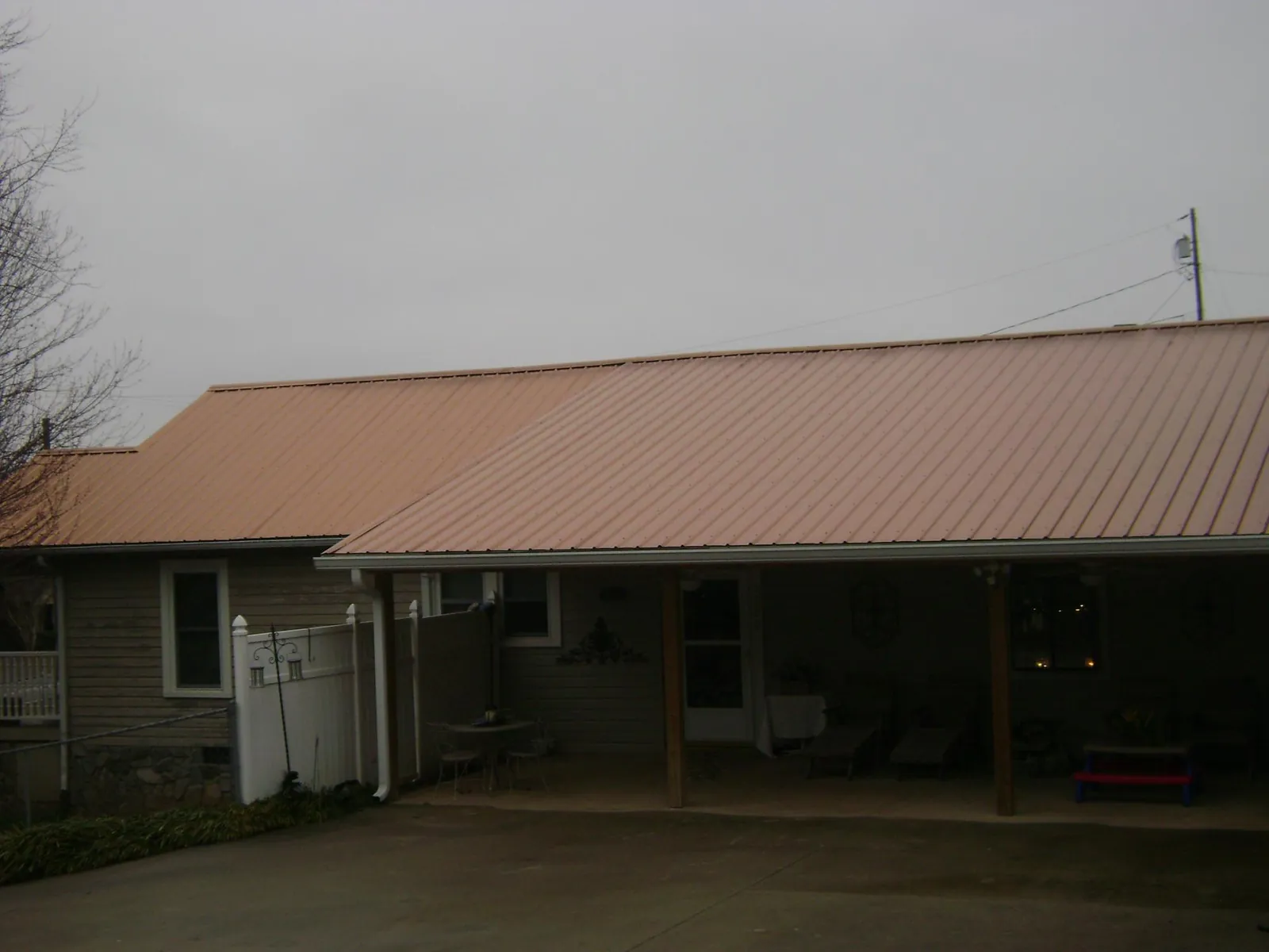 Copper toned metal roof over a wide covered patio in Bridgeville
